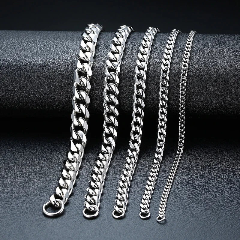 Set of silver chain bracelets on a dark surface