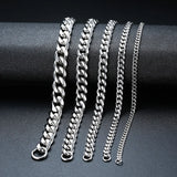 Set of silver chain bracelets on a dark surface