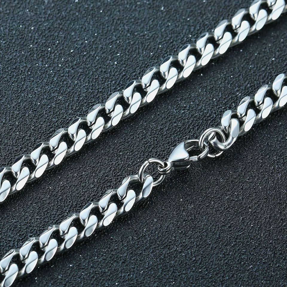 Silver chain necklace on a dark textured surface