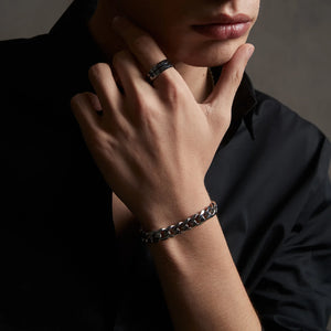 Black chain bracelet with a measurement label on a white background